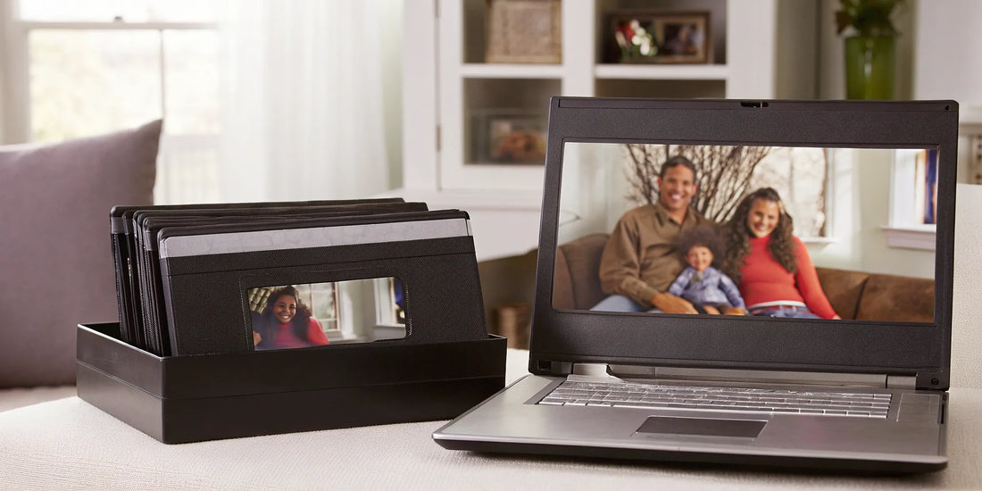 VHS to digital conversion setup with tapes and laptop.