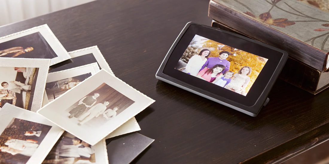 Photographic slides next to digital photo frame.