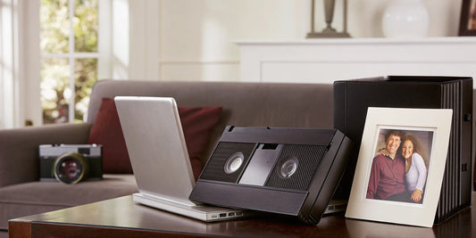 Converting VHS tapes to digital files on a laptop.