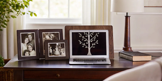 Digital family tree displayed on a laptop with family photos.