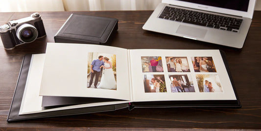 Digitizing scrapbook with camera and laptop.