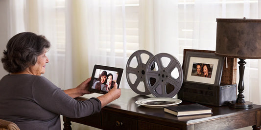 Woman preserving family history with digital tablet.