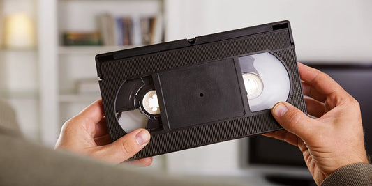 A person beginning the process of a DIY VHS tape repair.