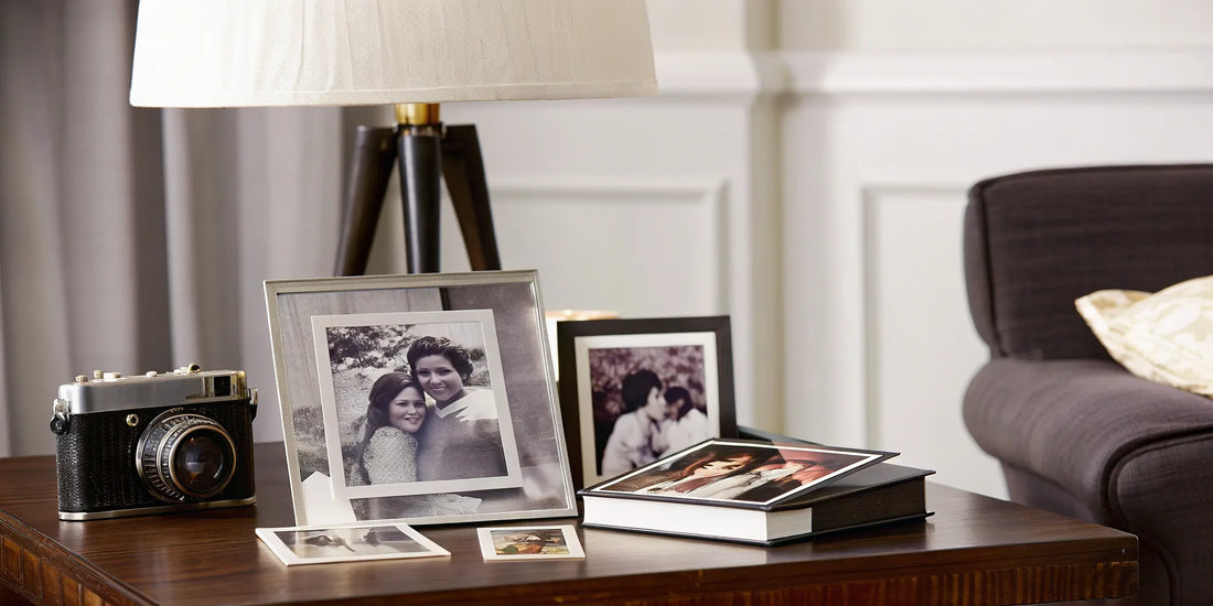 A collection of old photos and albums on a table, organized for long-term storage.