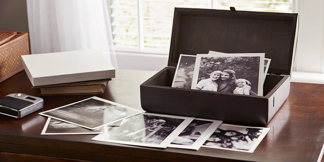 Old printed photos in a box ready for digital scanning.