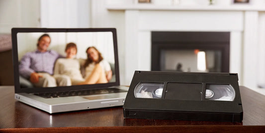 Transferring VHS tape to digital format on a laptop.