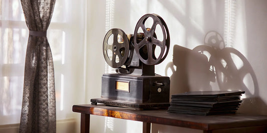 Two 16mm film reels loaded onto a vintage movie projector.