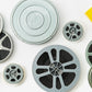 Assorted film reels and metal canisters with Kodak boxes on a white background